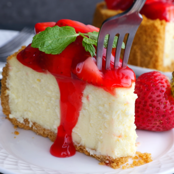 slice of strawberry cheesecake with a fork.