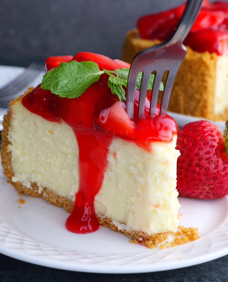 slice of strawberry cheesecake with a fork.