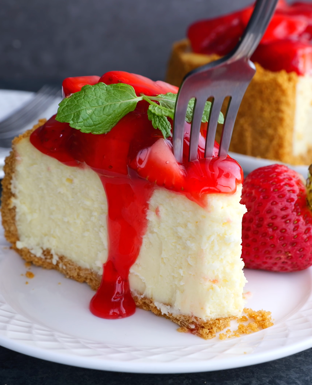 slice of strawberry cheesecake with a fork. 
