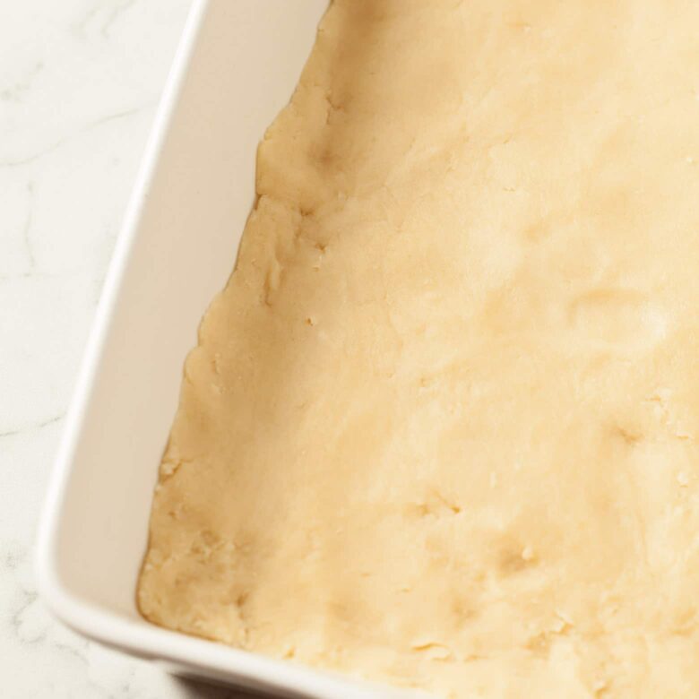 almond bars shortbread dough pressed into pan.