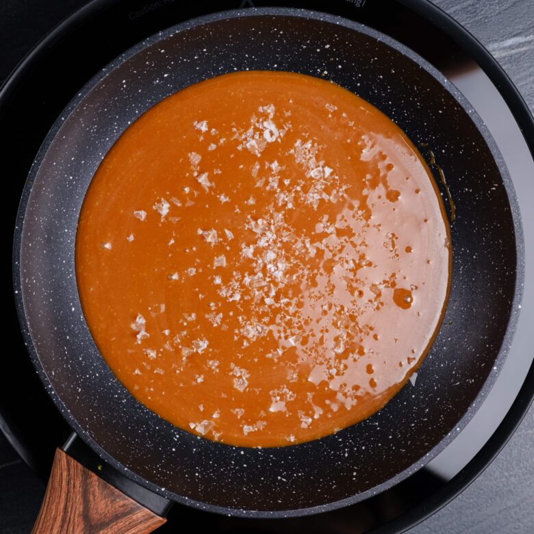 salted caramel sauce for cheesecakes in a saucepan.