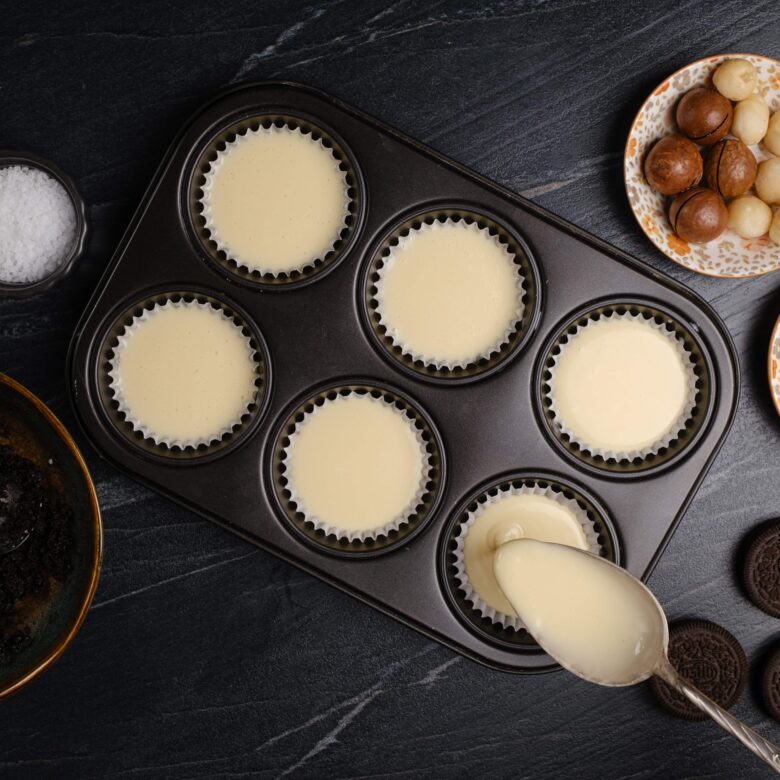 salted caramel cheesecake bite filling poured into muffin tins.