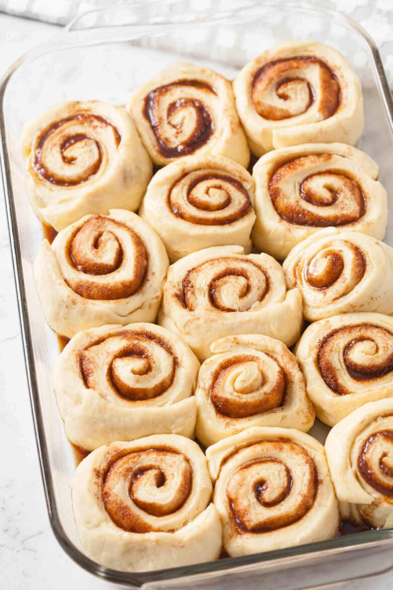 Overhead shot of unbaked cinnamon rolls in a baking dish.