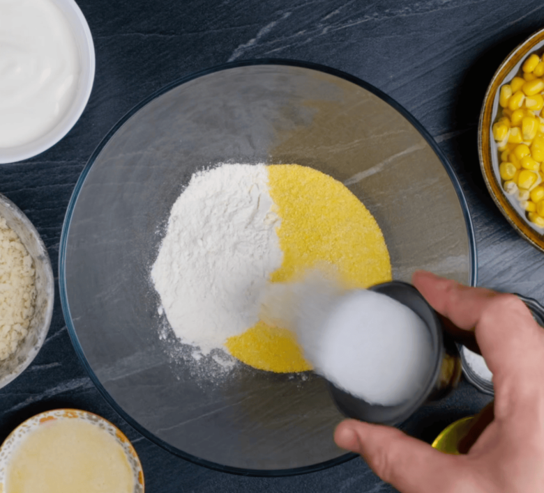 Easy corn casserole dry ingredients in a large glass bowl.