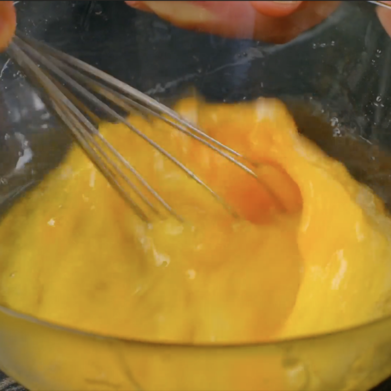 Egg mixture being whisked to make almond biscotti.