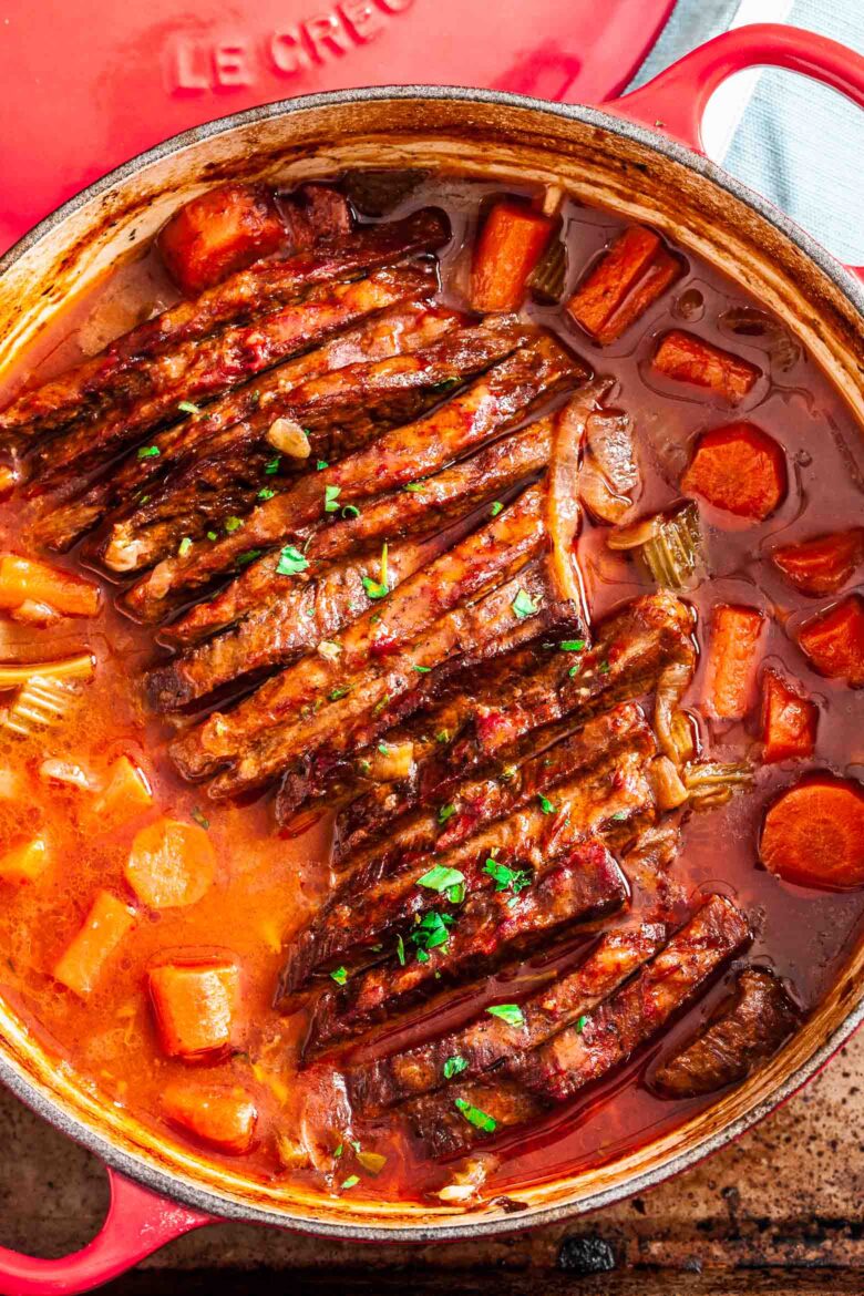 Overhead shot of tender braised brisket in a Dutch oven.