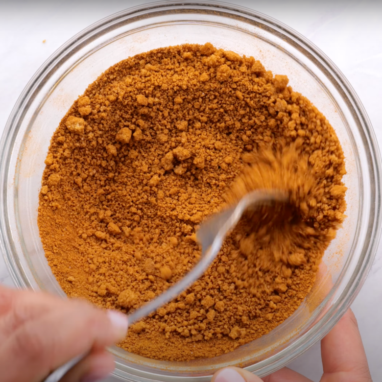 Cinnamon roll filling being mixed together in a large bowl.