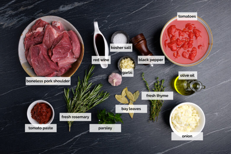 Overhead shot of all ingredients required to make pork ragu and neatly labeled. 