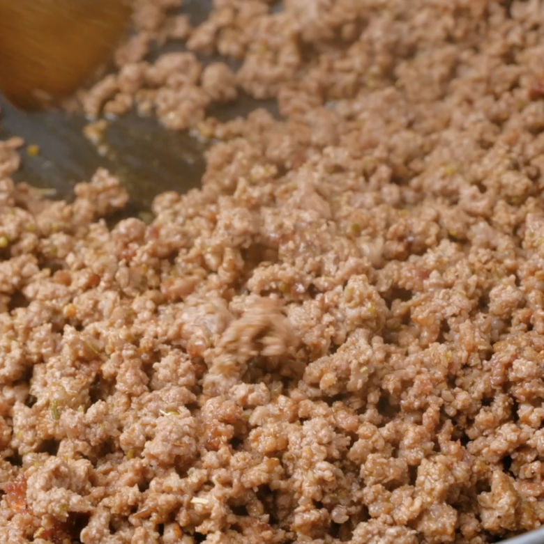 Ground beef being cooked in a skillet to make taco casserole.