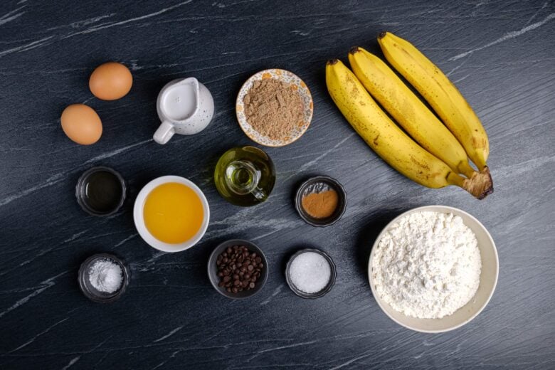 Overhead shot of igredients for dairy-free banana on a black table.