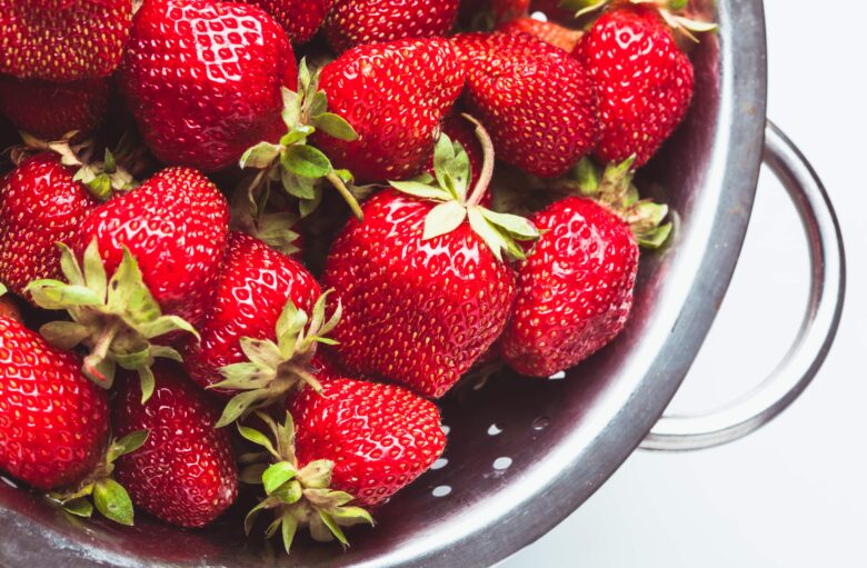 Fresh strawberries in a colander. 