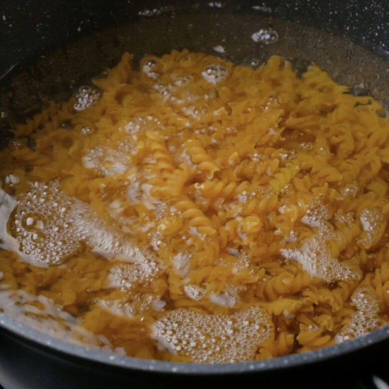 Pasta being boiled in a pot.