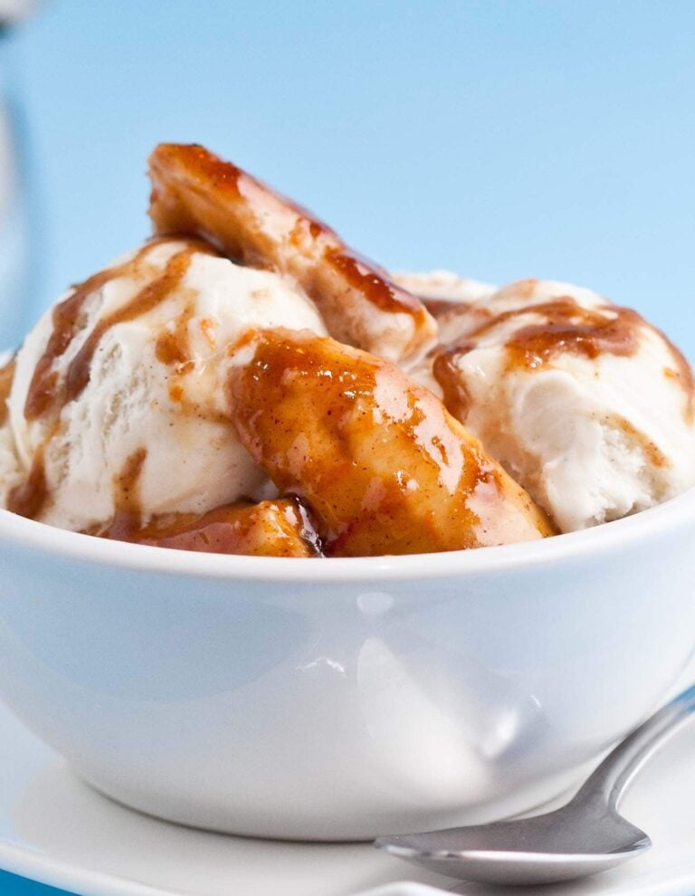 A bowl of Bananas Foster ice cream with a spoon on the side.