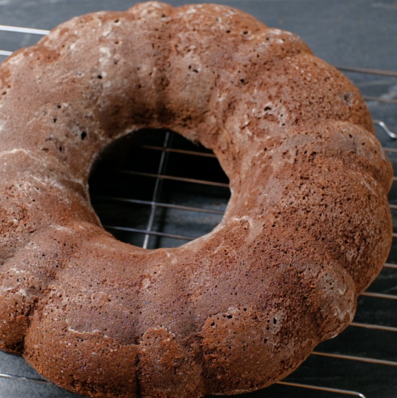 Freshly baked healthy chocolate cake on a wire rack.