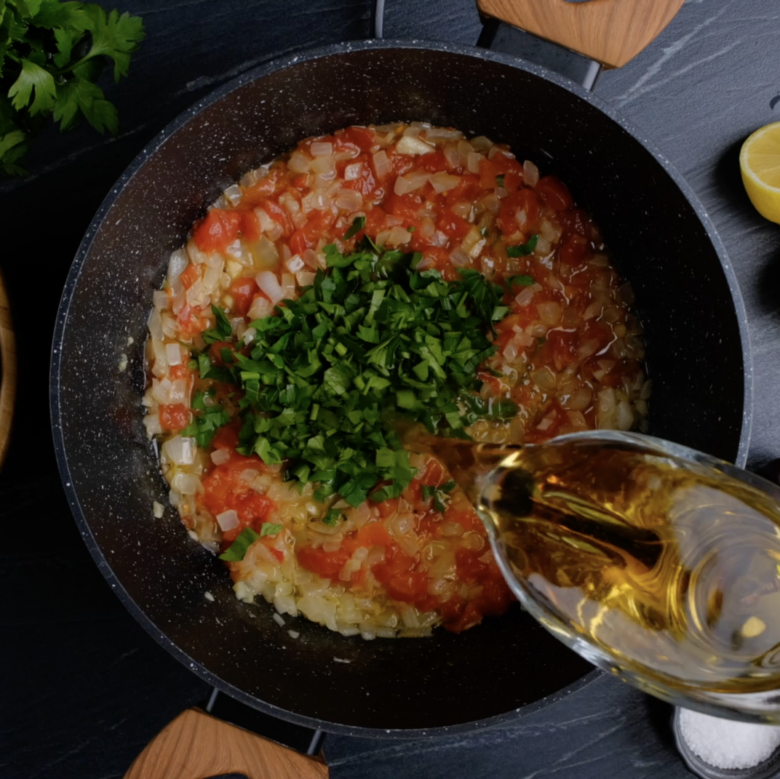 White wine sauce for mussels being cooked in a pot.