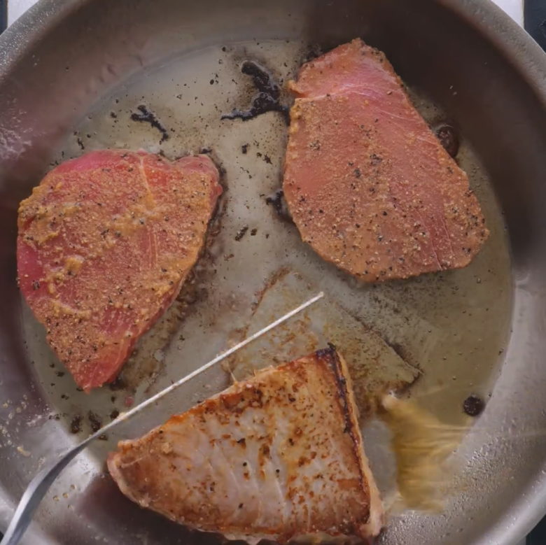 Ahi tuna searing on first side.