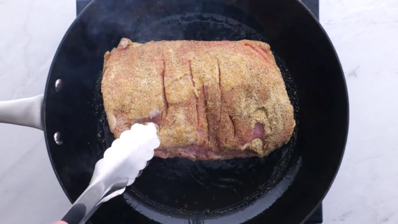 slow cooker pork loin being browned.
