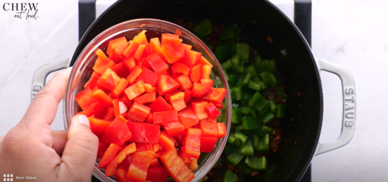 bell peppers being added to vegetarian chili.