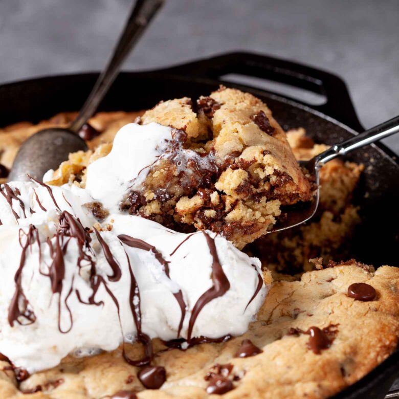 skillet chocolate chip cookie cake being eaten.