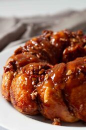 Easy stick buns with caramel-like sauce and pecans on a plate.