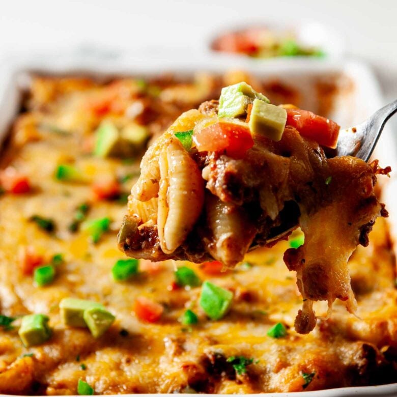 Taco Pasta in casserole dish served with tortilla chips and salsa. 