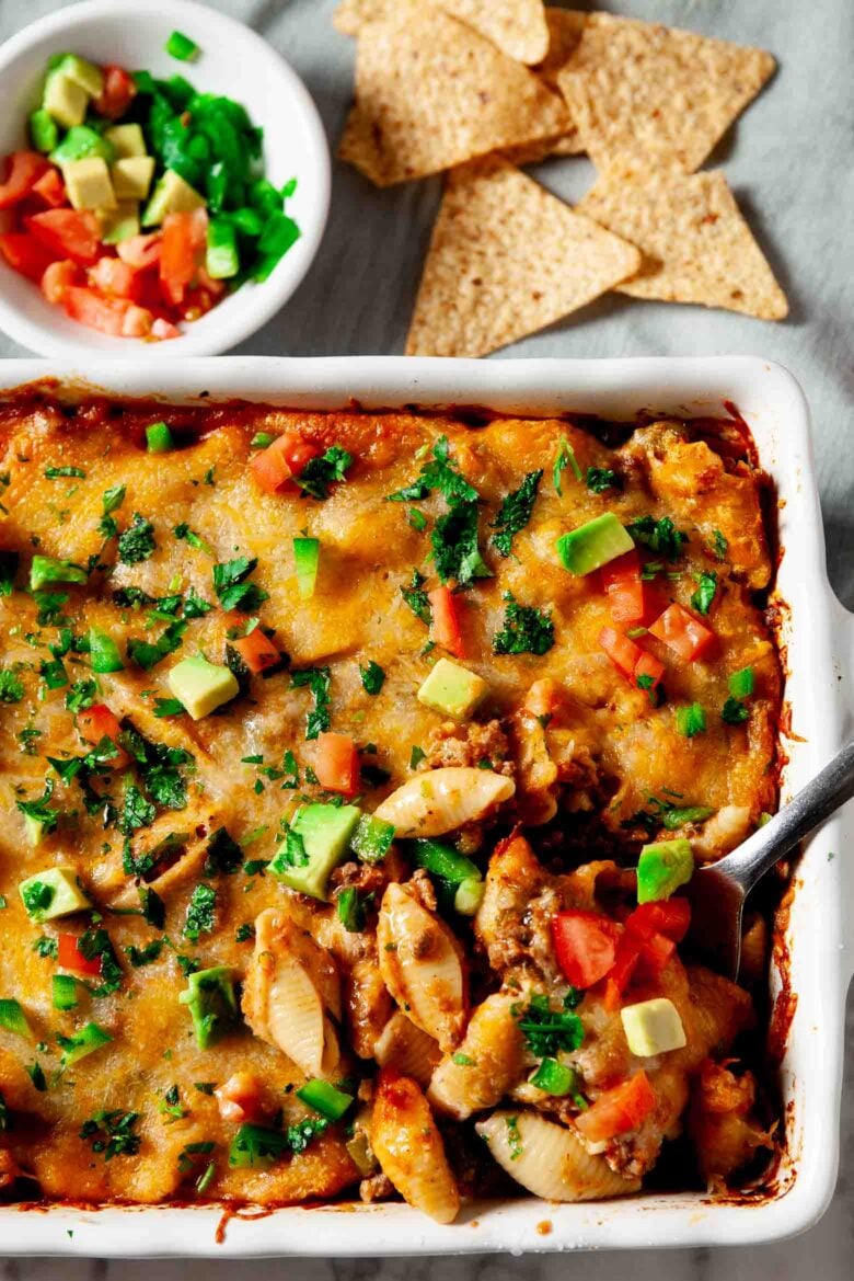 Taco Pasta in casserole dish served with tortilla chips and salsa.