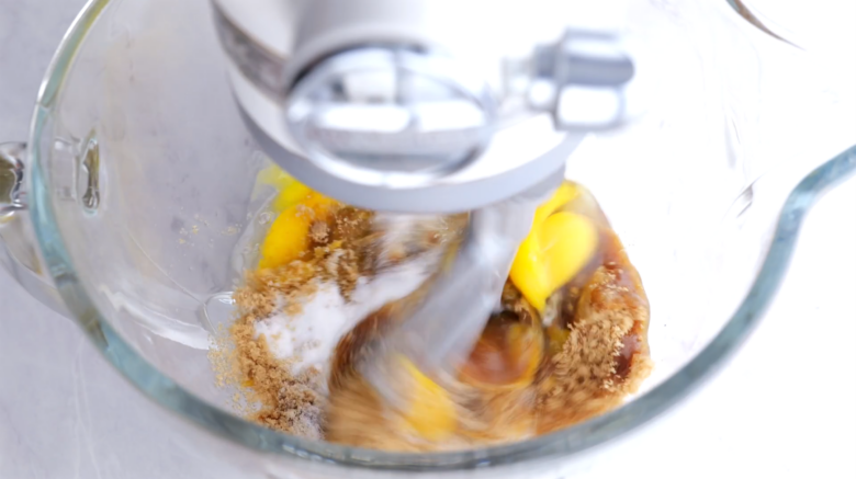 Egg and sugar mixture being beaten together to make carrot cake.