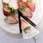 Overhead shot of a Chocolate Strawberry Cake topped with sliced fresh strawberries.