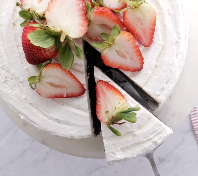 Overhead shot of a Chocolate Strawberry Cake topped with sliced fresh strawberries. 