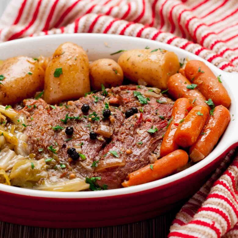 slow cooker corned beef and cabbage in a tray close up.