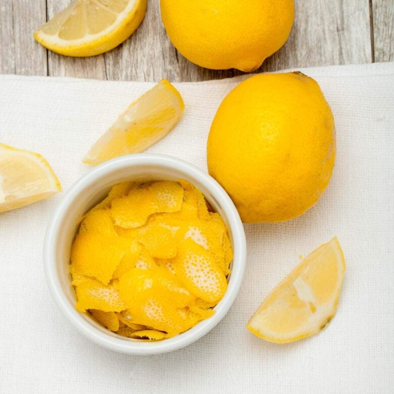lemon peel and fresh lemons for lemon custard cake.