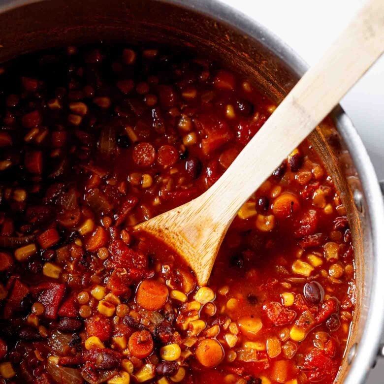 lentil chili with black beans in pot close-up.