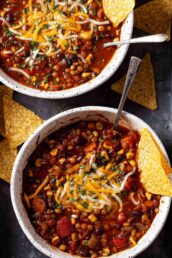 two bowls of lentil chili with black beans.