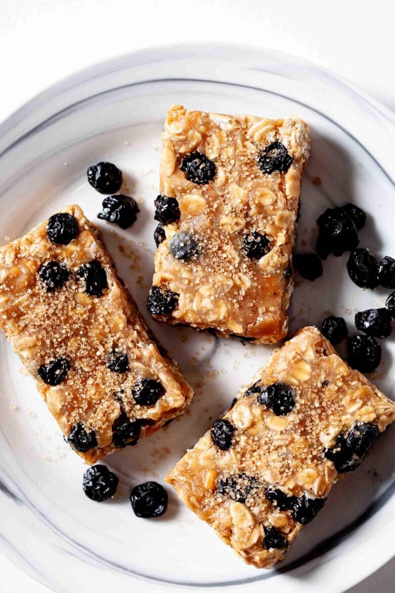 cut protein bars on a plate with dried blueberries. 