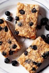 homemade protein bars with dried blueberries on a plate.