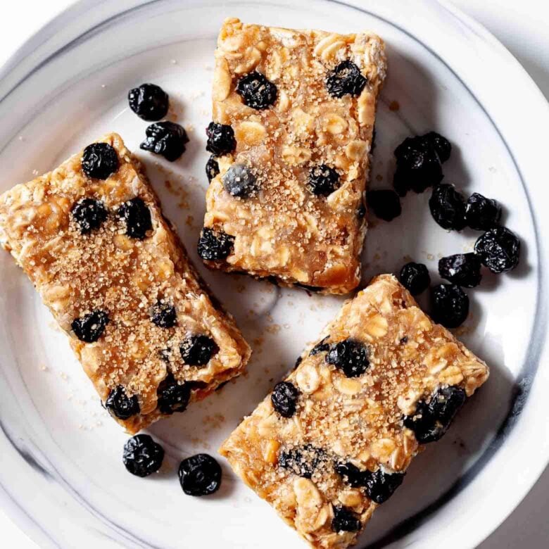 homemade protein bars with dried blueberries on a plate. 