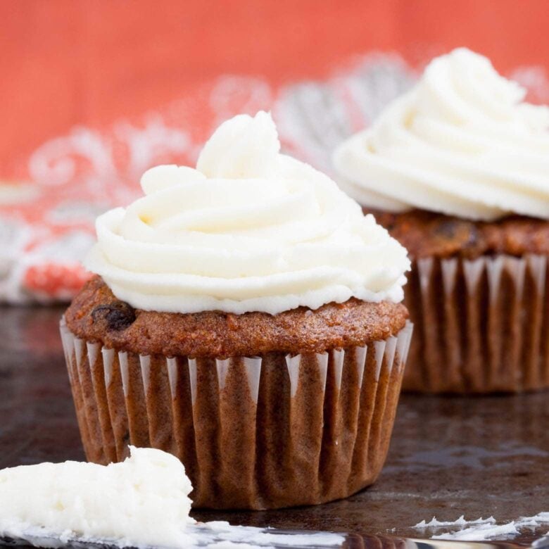 close up of carrot cake cupcakes with cream cheese frosting.