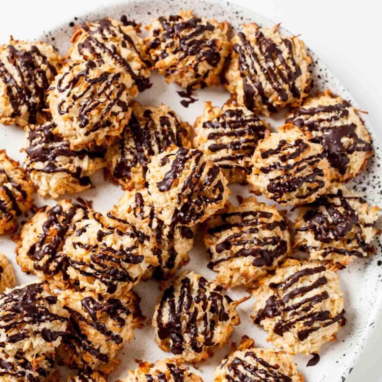 chewy coconut macaroons stacked on a plate.