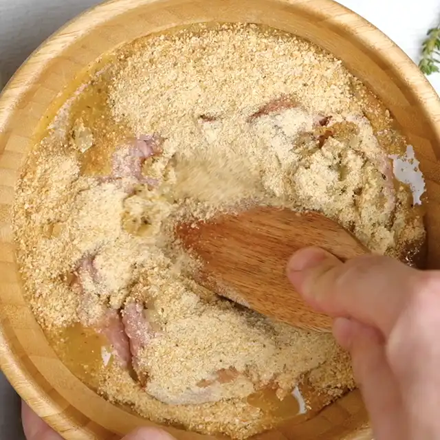 Ground beef being mixed with breadcrumbs, sauces, and eggs to make meatloaf mixture.