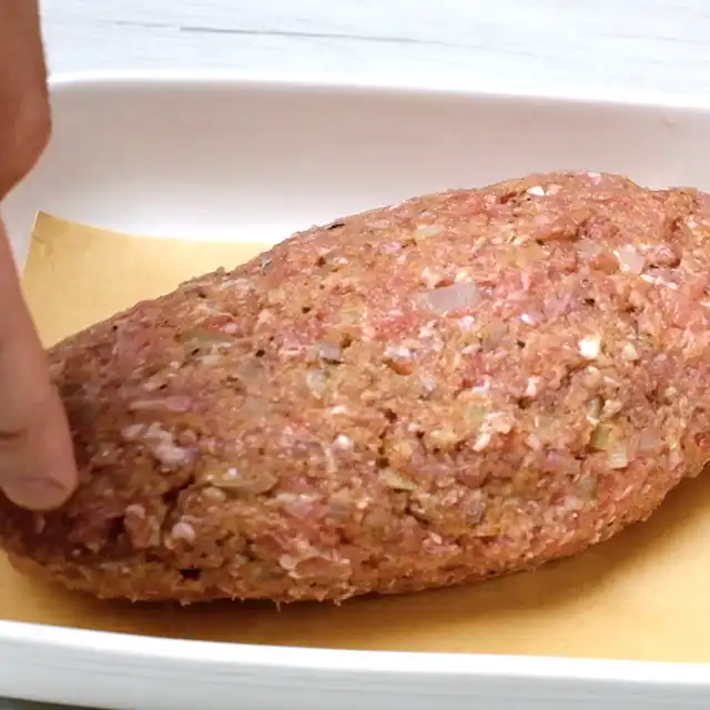 Meat mixture formed into a loaf to make the best meatloaf recipe.