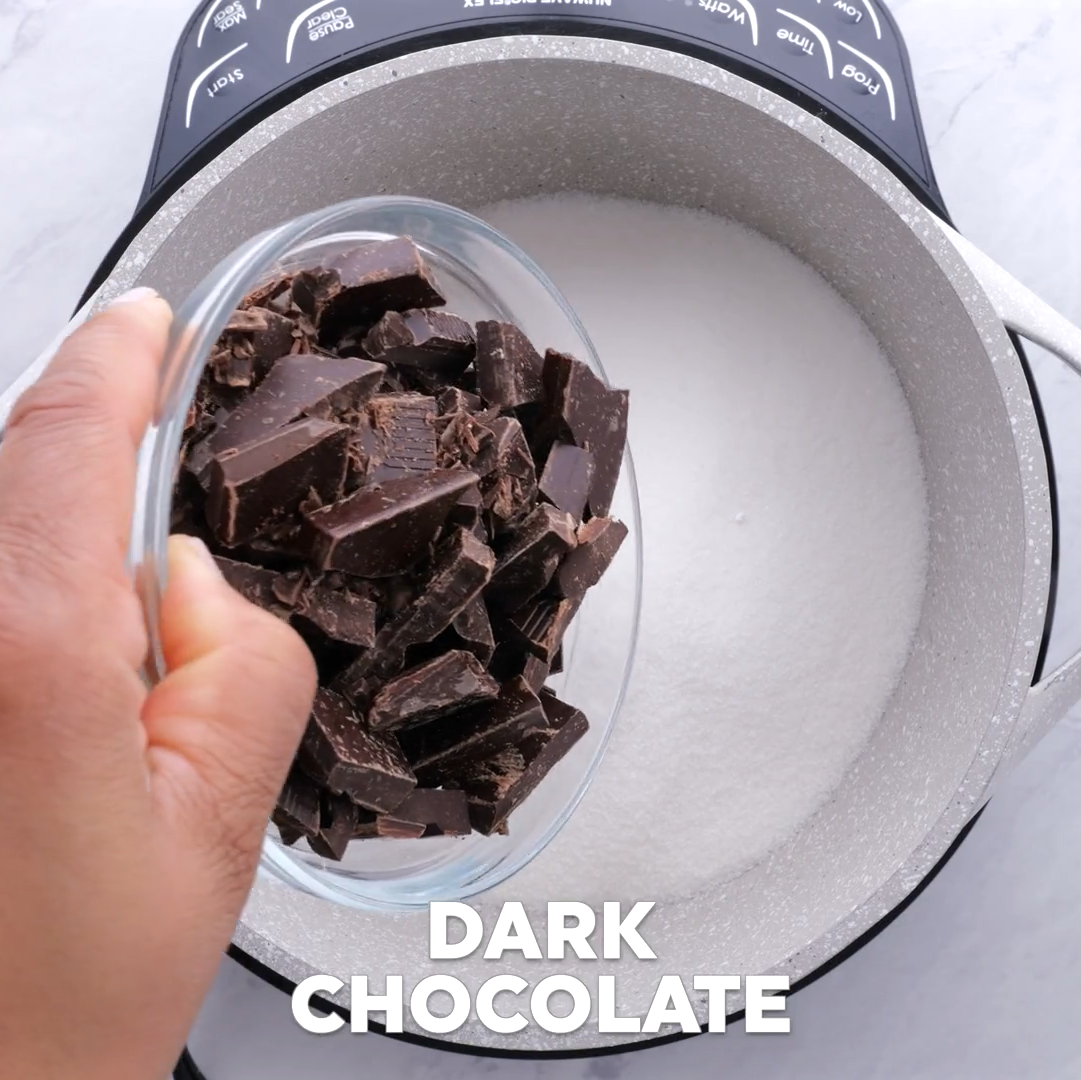 dark chocolate chunks added to saucepan for easy chocolate sheet cake.
