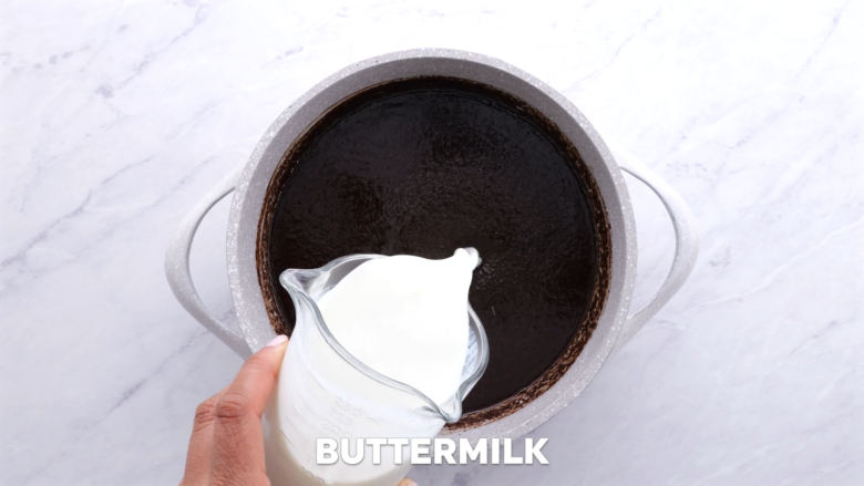 buttermilk added to saucepan for easy chocolate sheet cake.