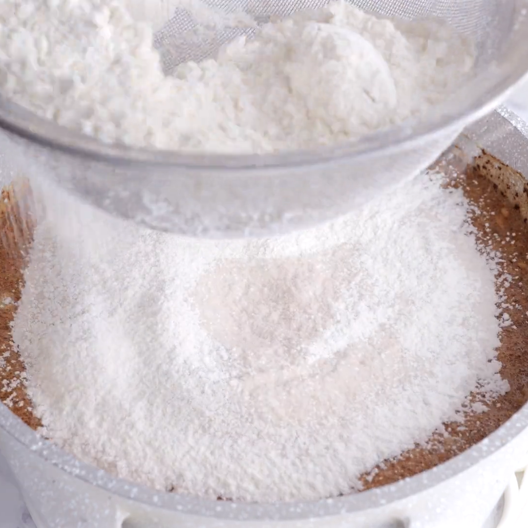 dry ingredients sifted into wet ingredients for easy chocolate sheet cake.