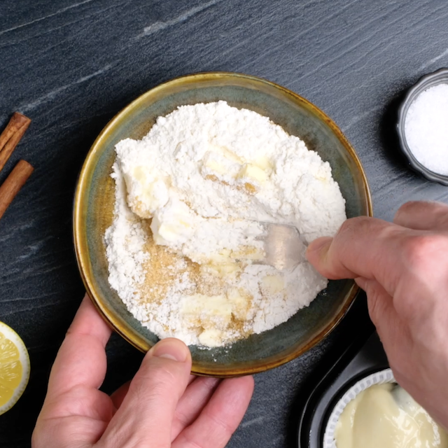 Streusel ingredients being mixed in a bowl.