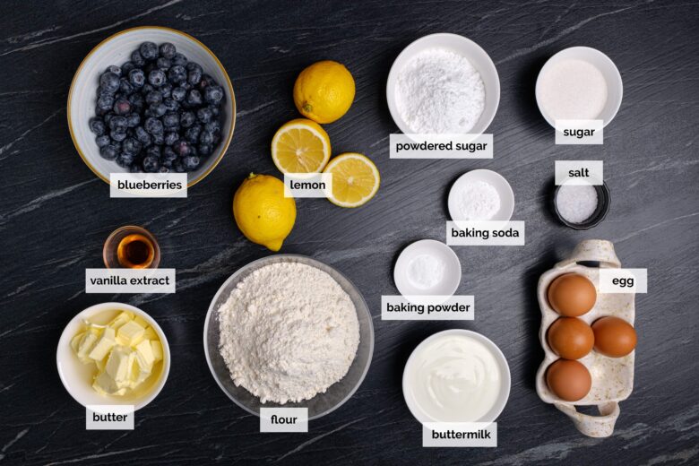 Overhead shot of lemon blueberry bundt cake on a dark surface.