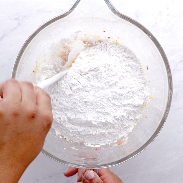 Overhead shot of bowl with flour mixture being incorporated into the batter.