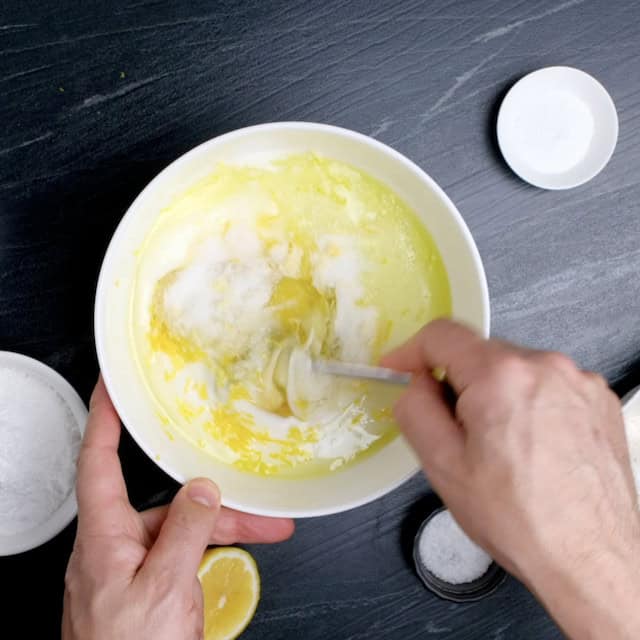 Lemon olive oil batter ingredients being whisked together.