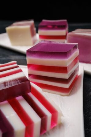 Closeup shot of sliced rainbow jello squares with clean lines.