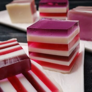 Closeup shot of sliced rainbow jello squares with clean lines.