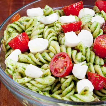 caprese pasta salad with mozzarella and pesto.